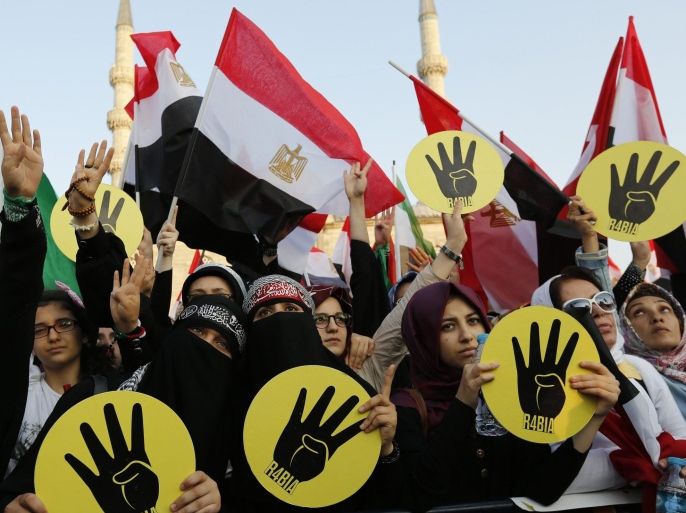 Supporters of Egypt's deposed Islamist President Mohamed Mursi and the Muslim Brotherhood wave Egyptian flags during a rally in protest against the recent violence in Egypt, outside of the Eminonu New mosque in Istanbul August 17, 2013.