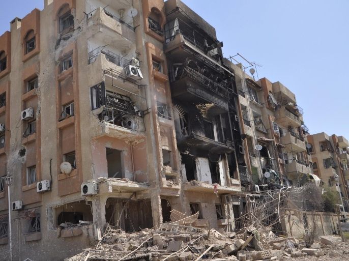 Damaged buildings are pictured after what activists said were eight barrel bombs thrown by forces loyal to Syria's President Bashar Al-Assad in Yarmouk camp April 14, 2015. Picture taken April 14, 2015. REUTERS/Moayad Zaghmout