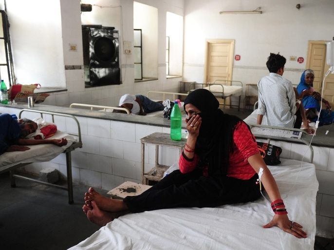 Indian diarrhoea patient Nansi Bano gestures as she sit on a bed in a government hospital in Allahabad on May 28, 2015, as scorching weather conditions continue across India. Hospitals in India were struggling to cope with an influx of victims of a blistering heatwave that has claimed nearly 1,500 lives in just over a week. AFP PHOTO/SANJAY KANOJIA