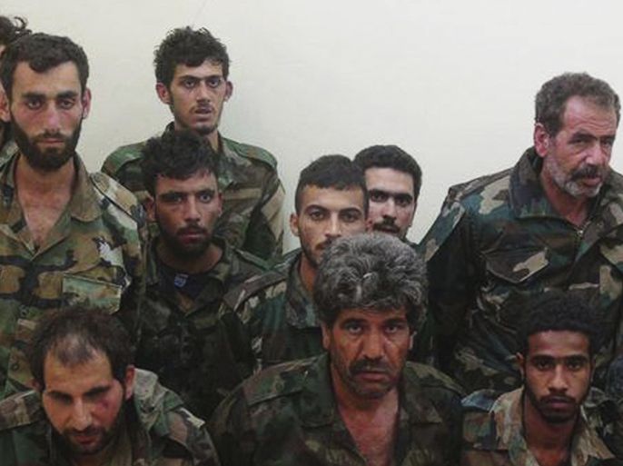 This picture released on Sunday, May 24, 2015, by a militant website which had been verified and is consistent with other AP reporting shows Syrian government soldiers who were captured by Islamic state militants in Palmyra area in Syria. The Syrian army is deploying troops in areas near the ancient town of Palmyra in apparent preparation for a counterattack to retake it from the Islamic State group, an official said. (Militant website via AP)