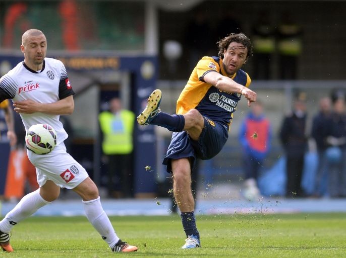 VERONA, ITALY - APRIL 04: Luca Toni (R) of Hellas Verona is challenged by Daniele Capelli of AC Cesena during the Serie A match between Hellas Verona FC and AC Cesena at Stadio Marc'Antonio Bentegodi on April 4, 2015 in Verona, Italy.