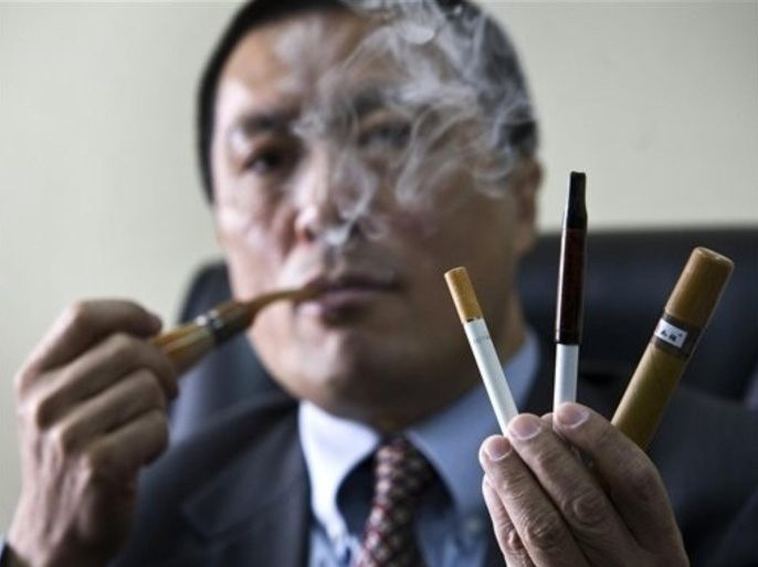 Miao Nan, executive director of Ruyan Group Ltd., puffs an electronic smoke while he shows other design during an interview at his office in Beijing, China, Tuesday, Feb. 17, 2009. Ruyan Group Ltd, Beijing-based company was the first to develop electronic cigarettes and says its patented atomizer technology allows users to get an immediate nicotine fix without being harmed by the hazardous chemicals produced when tobacco is burned.