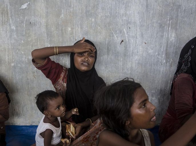 KUTA BINJE, INDONESIA - MAY 20: Rohingya women and children are seen after arriving at the port in Julok village on May 20, 2015 in Kuta Binje, Aceh Province, Indonesia. Hundreds of Myanmar's Rohingya refugees have arrived in Indonesia, many requiring medical attention. Thousands more are believed to still be stranded at sea reportedly with no country in the region willing to take them in. Myanmar's Rohingya Muslim community have long been persecuted and marginalized by Myanmar's mostly Buddhist population.