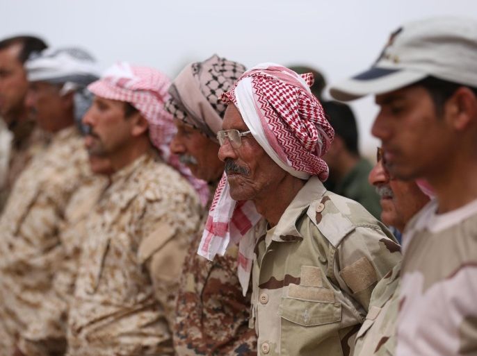 Sunni tribal volunteers stand in formation during their graduation ceremony in the town of Amiriyat al-Fallujah, west of Baghdad, Iraq, Friday, May 8, 2015. Iraqi authorities signed up on Friday the first batch of 1,000 for a new Sunni militia to help its security forces take back the western Anbar province from the Islamic State after years of reluctance to arm and train the tribal fighters. (AP Photo/Hadi Mizban)