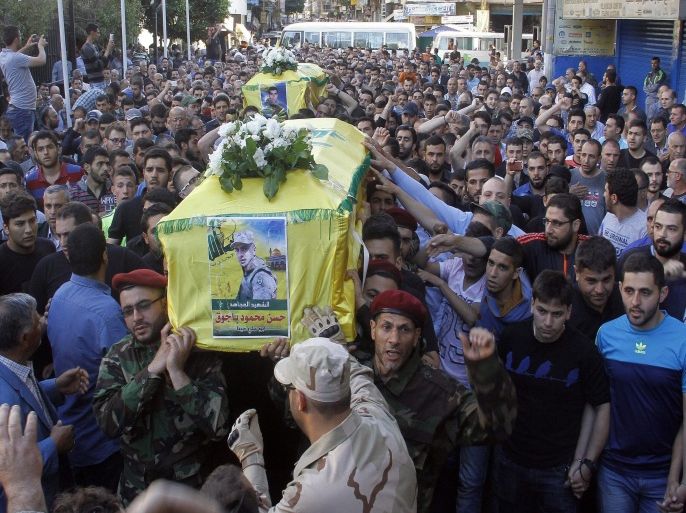 Fighters from Lebanon's Shiite movement Hezbollah carry the coffins of Shiite militants Khodr Aladdine and Hassan Bajouk during their funeral in the capital Beirut on May 8, 2015, after they were killed in combat alongside Syrian government forces in the Qalamun region. Syrian regime forces and Hezbollah fighters seized control on May 7, 2015, of several hilltops in the Qalamun region, a mountainous area which lies north of Damascus and runs along the Lebanese border. AFP PHOTO / STR