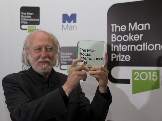 Hungary's Laszlo Krasznahorkai, the winner of the Man Booker International Prize, poses for photographers with the trophy shortly after the award ceremony at the Victoria and Albert Museum in London, Tuesday, May 19, 2015. The Man Booker International Prize is awarded every two years to a living author for a body of work published either originally in English or available in translation in the English language. (AP Photo/Matt Dunham)