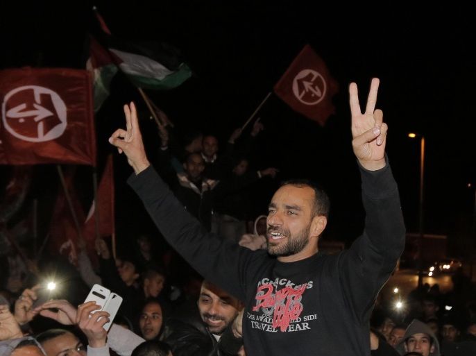 Released Palestinian prisoner Samer al-Issawi gestures as he celebrates in the East Jerusalem neighbourhood of Issawiya December 23, 2013. Israel on Monday freed al-Issawi from jail, to complete a deal agreed earlier this year over his release in exchange for him ending a lengthy hunger strike that almost killed him. REUTERS/Ammar Awad (JERUSALEM - Tags: POLITICS CIVIL UNREST)