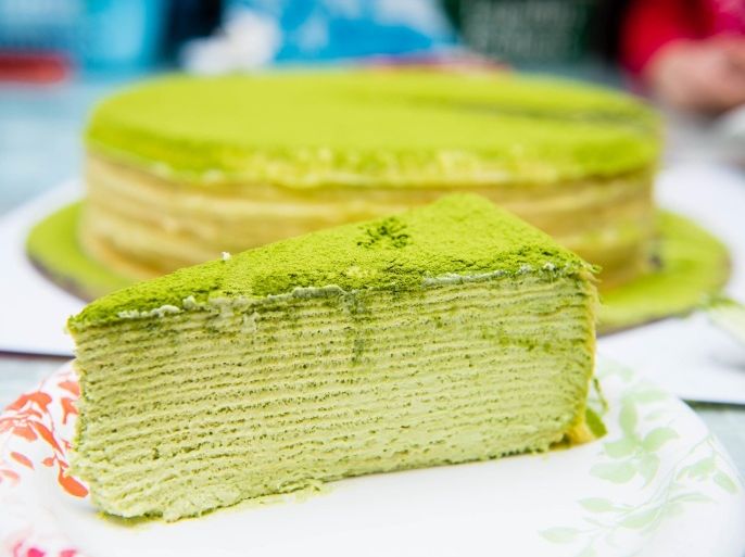 Close up of sliced delicious sweet pistachio cake on plate