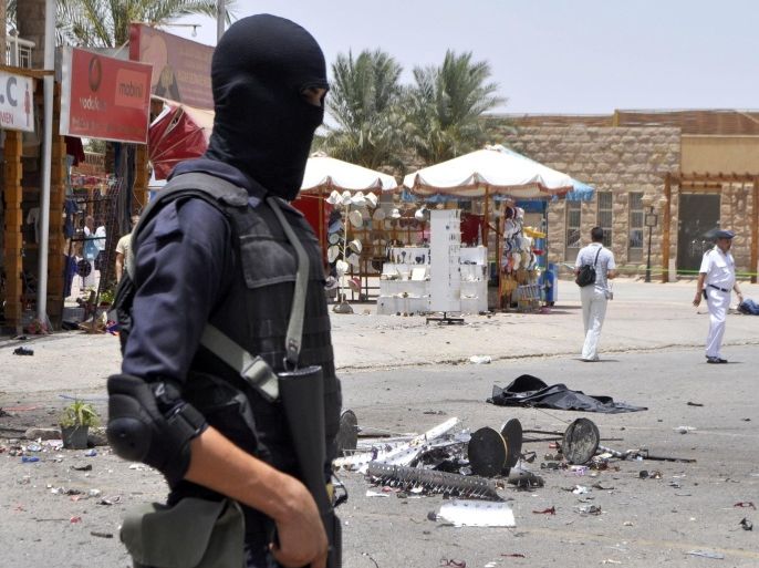 LUXOR, EGYPT - JUNE 10: An Egyptian security official stands guard at the site of a suicide car bomb attack near the ancient Karnak Temple in Egypts southern city of Luxor on June 10, 2015.