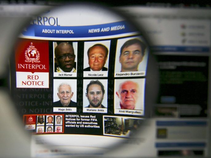 The homepage of the Interpol website is seen through a magnifying glass in this picture illustration taken in Berlin, Germany June 3, 2015. Interpol said on Wednesday it has issued international wanted-person alerts for two former FIFA officials including Jack Warner and four corporate executives at the request of U.S. authorities as part of a corruption probe. Interpol said it issued so-called red notices -- not an international arrest warrant -- for Warner, former President of CONCACAF, which governs football in North and Central America and the Caribbean, and Nicolas Leoz, the former head of South America's soccer federation. The others are Alejandro Burzaco, Hugo Jinkis and Mariano Jinkis, who are among soccer officials and sports media and promotion executives hit with U.S. graft charges involving more than $150 million in bribes, and Jose Margulies, a Brazilian citizen who headed two offshore companies that were involved in the broadcasting of soccer matches. REUTERS/Pawel Kopczynski TPX IMAGES OF THE DAY