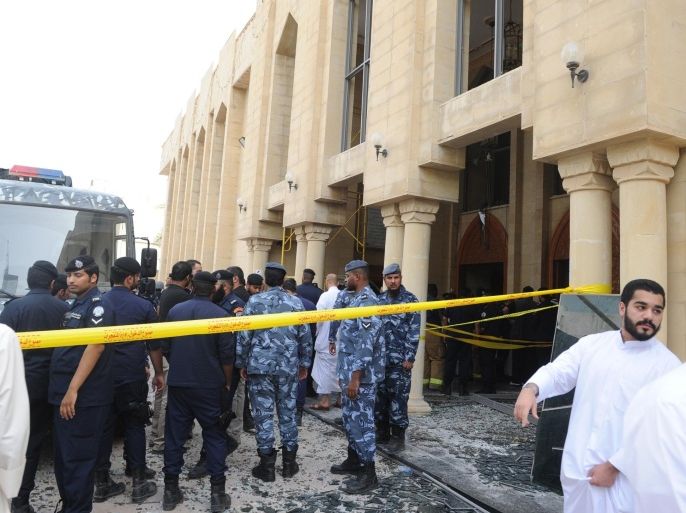 Security forces and officials gather at a Shiite mosque after a deadly blast claimed by the Islamic State group that struck worshippers attending Friday prayers in Kuwait City, Friday, June 26, 2015. (AP Photo)