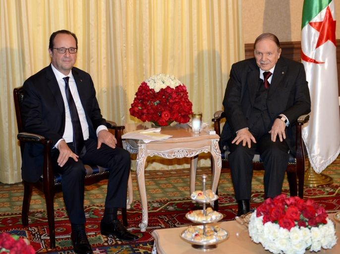 French President Francois Hollande, left, and Algerian President Abdelaziz Bouteflika, right, pose prior to a meeting in Algiers, Algeria, Monday, June 15, 2015. Hollande made a fleeting visit to Algiers for a few hours to meet his Algerian counterpart Abdelaziz Bouteflika. (AP Photo/Sidali Djarboub)