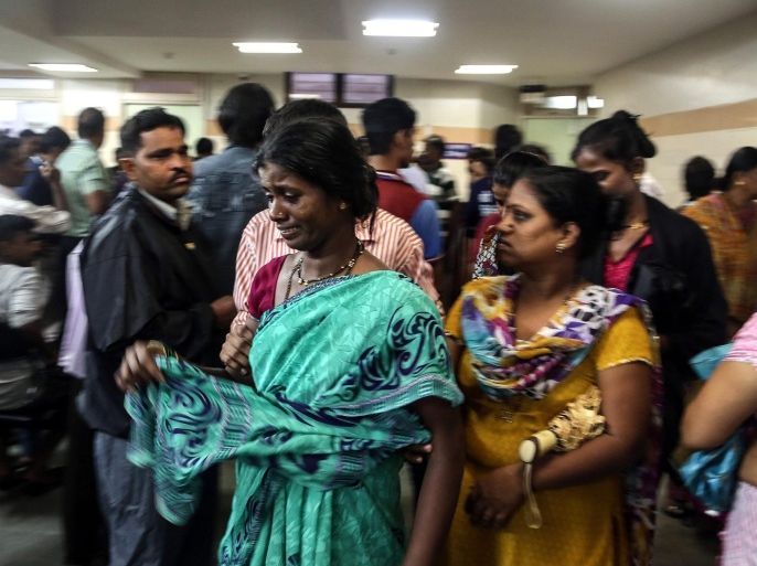 Relatives of people who died of consumption of poisonous liquor mourn at Shatabdi Municipal Hospital, in Mumbai, India, 19 June 2015. At least 33 people have died after consuming illegally brewed alcohol in India's western city of Mumbai's slums in the Malvani areas. Most of the victims were construction workers and auto rickshaw drivers and police have detained three suspects in connection with the deaths, and sent samples of the drink to be analyzed, a news reports said.