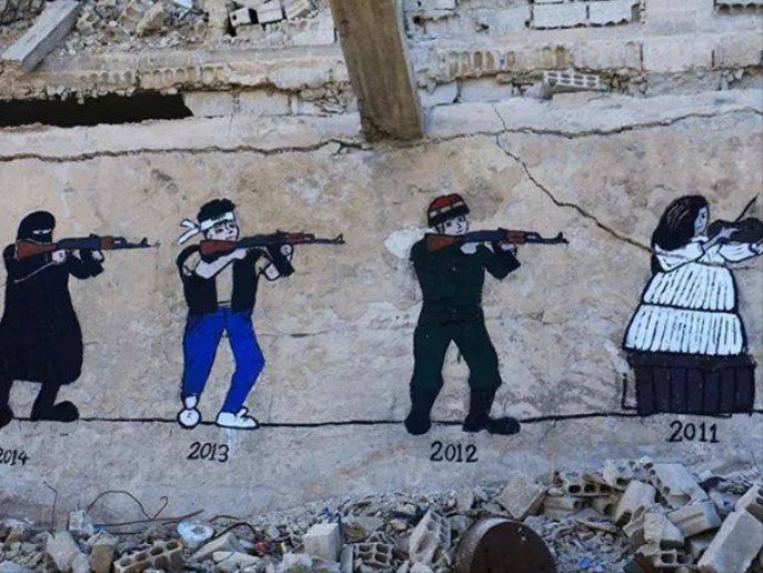 جانب من رسوم أبو مالك للثورة والأمل على جدران مدينة داريا (الجزيرة)