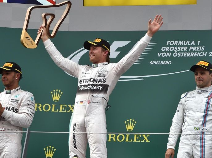 Mercedes AMG Petronas F1 Team's German driver Nico Rosberg (C) celebrates with the trophy on the podium next to Mercedes AMG Petronas F1 Team's British driver Lewis Hamilton (L) and Williams Martini Racing's Brazilian driver Felipe Massa after the Red Bull Ring in Spielberg, Austria on June 21, 2015, during the Austrian Formula One Grand Prix. Germany's Nico Rosberg won the Austrian Grand Prix ahead of British teammate and overall drivers standings leader Lewis Hamilton, with Brazilian Felipe Massa, in a Williams, in third 17sec off the pace. AFP PHOTO / ANDREJ ISAKOVIC