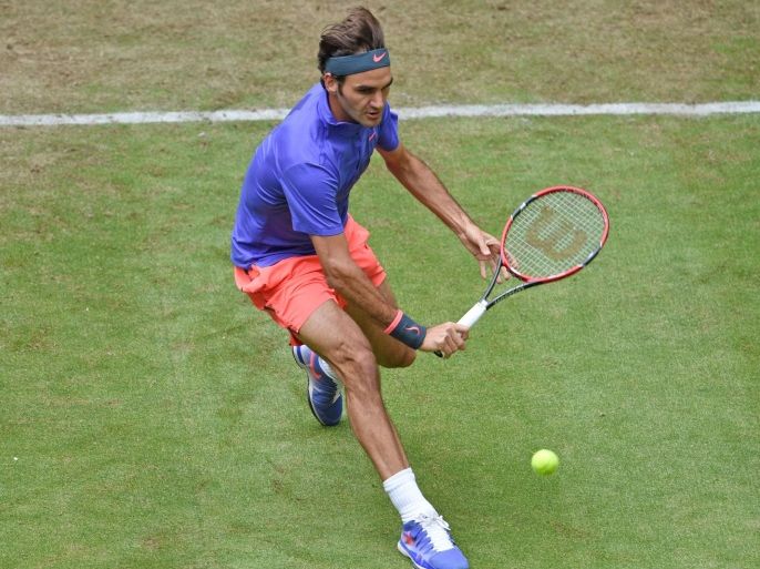 HALLE, GERMANY - JUNE 17: Roger Federer of Switzerland plays a backhand in his match against Ernests Gulbis of Latvia during day three of the Gerry Weber Open at Gerry Weber Stadium on June 17, 2015 in Halle, Germany.