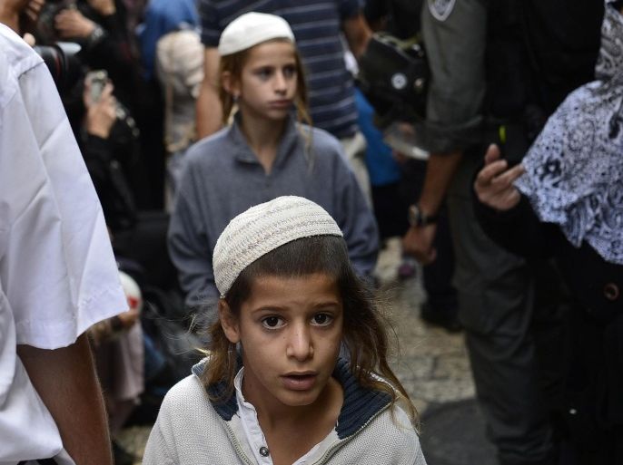 JERUSALEM, ISRAEL - OCTOBER 14: Jewish kids are seen as Israeli security men do not allow Palestinian Muslims during a tension moment between Israeli security forces and Palestinian Muslims at Chain Gate of Al Aqsa Mosque closed to Muslims and, in Jerusalem, Israel on October 14, 2014. Israeli Jewish people are free to enter the Al Aqsa.