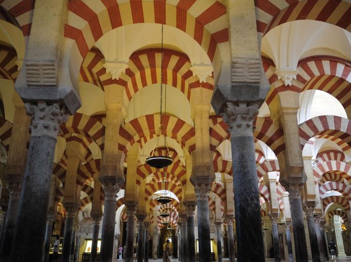 FILE - In this Aug. 6, 2009 file photo, tourists visit the Great Mosque of Cordoba in southern Spain. The regional government of southern Andalusia is protesting what it says are moves by the Catholic Church to downplay or eliminate references to the Islamic past of Cordoba's ancient Mosque-Cathedral, one of Spain's leading tourist attractions.The region’s tourism department says the practice by church authorities who own the complex of calling it simply “The Cordoba Cathedral” on its web site and on pamphlets and tickets could hurt tourism and confuse the 1 million-plus tourists who annually visit the “mezquita” (mosque), as it is known popularly. The tourism department said Monday Dec. 15, 2014 it had sent a letter seeking a meeting with the church. (AP Photo/Manu Fernandez, File)