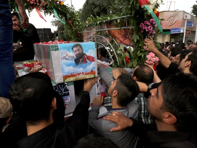 : Iranian mourners carry the coffins of Mohammad Hamidi, Hasan Ghafari and Ali Amrai, members of the Islamic Republic's Revolutionary Guards reportedly killed in Syria, during their funeral in Tehran on June 25, 2015. According to Iran's Revolutionary Guards, the three men have been killed in fighting against the Islamic State (IS) jihadist group. AFP PHOTO / ATTA KE