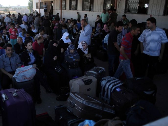 Palestinians gather at the Rafah border crossing in the southern Gaza Strip, as they await permission to enter Egypt on June 13, 2015. Egypt is due to reopen its Rafah border crossing with Gaza for three days. The Rafah crossing point between Egypt and the Gaza Strip will open three days from Saturday to allow entry and exit of Gazan patients and students, Palestinian and Egyptian officials said. AFP PHOTO / SAID KHATIB