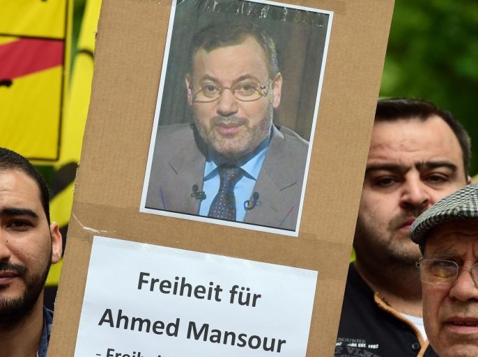 Supporters of ousted Egyptian Islamist president Mohamed Morsi stage a demonstration to ask for the release of detained Al-Jazeera journalist Ahmed Mansour in front of the local court of Berlin's Tiergarten district, where Mansour is being held in custody, awaiting a judge's decision on his further detention, on June 21, 2015. In the case that has raised issues about press freedom and German relations with Egypt under President Abdel Fattah al-Sisi, Mansour was arrested Saturday (June 20, 2015) at a Berlin airport having been accused by Cairo of committing 'several crimes'. AFP PHOTO / JOHN MACDOUGALL
