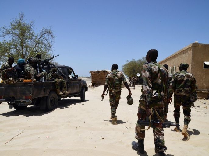 Nigerien soldiers patrol along the Nigerian border, near the south-eastern city of Bosso, on May 25, 2015. Niger has extended for three months the state of emergency in its southeastern Diffa region where the army has been battling Boko Haram militants since February, authorities announced on May 27, 2015. The operation, nicknamed Barkhane, which succedeed to Serval one, is taking place across Mauritania, Mali, Burkina Faso, Niger and Chad and involves a total 3,000 French troops. AFP PHOTO / ISSOUF SANOGO
