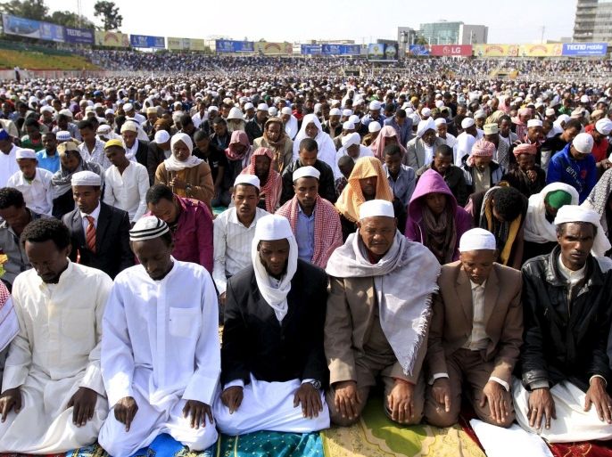 Men take part in morning prayers to celebrate the first day of the Muslim holiday of Eid-al-Fitr, marking the end of the holy month of Ramadan, in Ethiopia's capital Addis Ababa, July 17, 2015. REUTERS/Tiksa Negeri