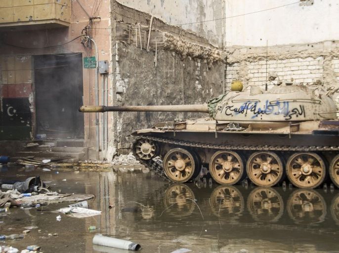 In this photo taken March 3, 2015, a tank stands amongst damaged buildings in Benghazi, Libya. Destruction has permeated the North African country since the civil war ousted Moammar Gadhafi four years ago. For Benghazi, the past year was the worst. (AP Photo/Mohamed Salama)