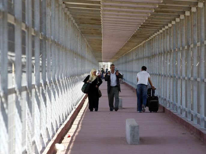 FILE - In this file photo taken Tuesday, May 4, 2010, Palestinians walk inside a newly built passageway on the Palestinian side of the Erez crossing, northern Gaza Strip. Renewed Israel-Hamas fighting after the collapse of truce talks in Cairo on Tuesday, Aug. 19, 2014 highlights the steep obstacles to ending the Gaza war. (AP Photo/Hatem Moussa, File)
