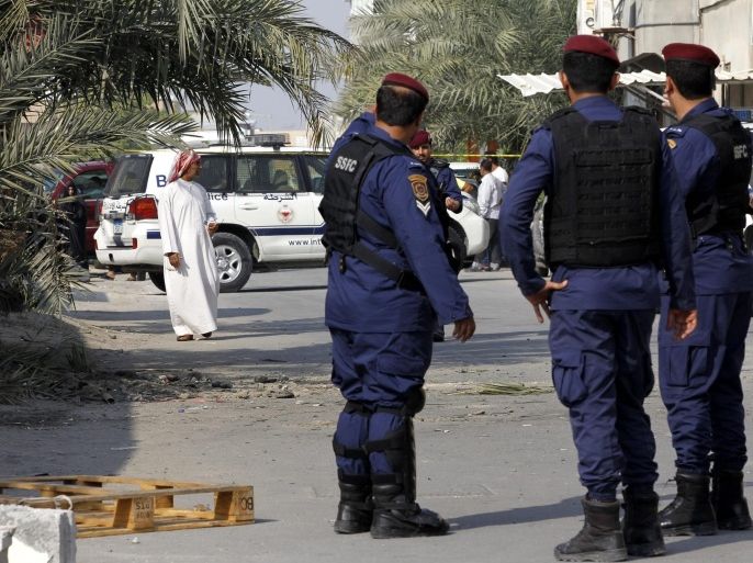 Policemen stand at the scene of bombing in Karzakan village, north of Bahrain, 09 December 2014. Bahraini Interior Ministry said a bomb blast killed a Bahraini civilian on 09 December. The blast followed an explosion on 08 December night in a Shiite town which killed a Jordanian police officer serving with local authorities. A relatively unknown group, al-Ashter Brigades, claimed the attack on the police. The group is believed to be made up of Shiite radicals who are opposed to the Sunni monarchy.