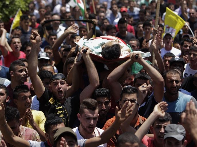 Palestinian mourners carry the body of 21-year-old Mohammed Ahmed Alauna, who was killed in clashes with Israeli troops in the West Bank village of Burqin, near Jenin on Wednesday, July 22, 2015. The Israeli military said its troops were on a routine patrol in the West Bank when they were attacked by a group of Palestinians hurling rocks in their direction. (AP Photo/Mohammed Ballas)
