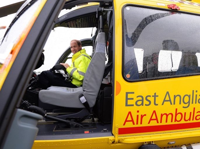 CAMBRIDGE , UNITED KINGDOM - JULY 13: Prince William, The Duke of Cambridge sits in the cockpit of an helicopter as he begins his new job with the East Anglian Air Ambulance (EAAA) at Cambridge Airport on July 13, 2015 in Cambridge, England. The former RAF search and rescue helicopter pilot will work as a co-pilot transporting patients to hospital from emergencies ranging from road accidents to heart attacks.