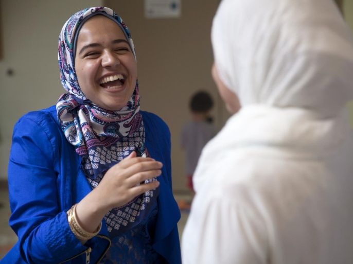 Flushing resident Nusayba Tabbah, 17, laughs as she takes a break from setting up decorations at the Flint Islamic Center on Tuesday, July 9, 2013 in preparation for the Islamic tradition of Ramadan that starts Wednesday, July 10. Hundreds are expected to gather at the center for the Terawih prayer, which leads into a month of fasting -- or sawm -- and prayer.