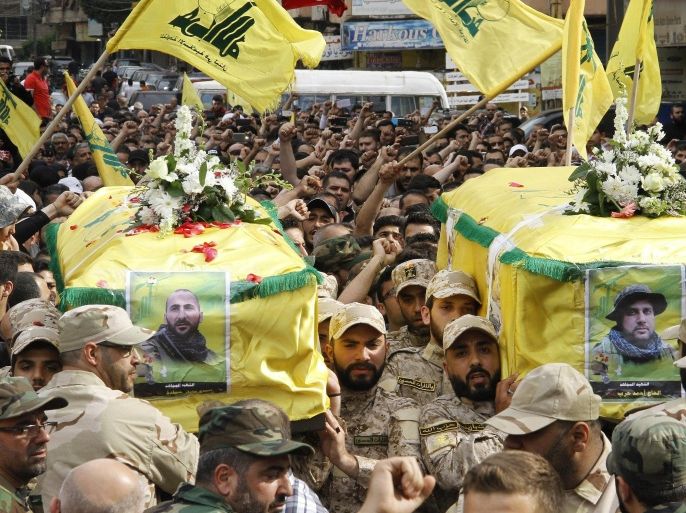 Fighters from Lebanon's Shiite movement Hezbollah carry the coffins of fellow militants, Ahmed Hareb (R) and Adel Hamidi during their funeral on June 6, 2015 in a southern suburb of the Lebanese capital Beirut after they were killed in combat alongside government forces in the Syria. AFP PHOTO / STR
