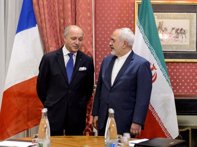 French Foreign Minister Laurent Fabius (L) speaks with his Iranian counterpart Mohammad Javad Zarif at the opening of a bilateral meeting on nuclear talks on March 28, 2015 in Lausanne. Fabius joined US Secretary of State John Kerry and their Iranian counterpart Mohammad Javad Zarif ahead of a March 31 deadline to agree the contours of what they hope with be a historic agreement. AFP PHOTO / FABRICE COFFRINI