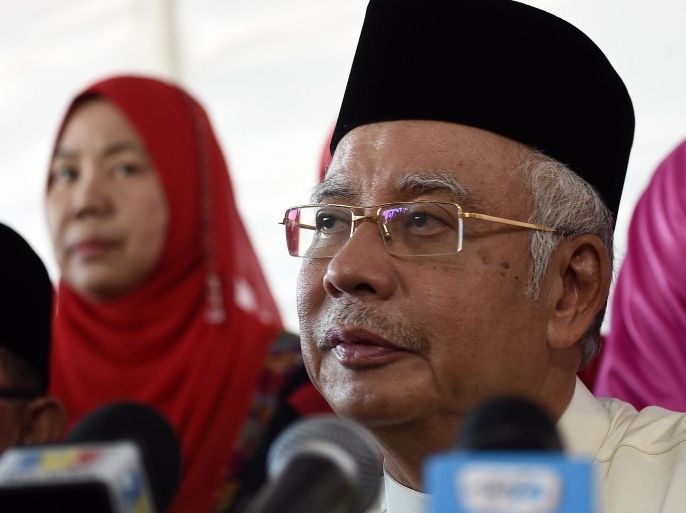 Malaysia's Prime Minister Najib Razak addresses the media at a mosque in Semenyih on the outskirts of Kuala Lumpur on July 5, 2015. A task force is investigating allegations that a probe into a Malaysian state-controlled investment fund found hundreds of millions of dollars were transferred to the prime minister's personal bank accounts, the attorney general has said. The allegations have set off a storm in Malaysia, with premier Najib threatening to sue the Wall Street Journal for publishing the report, while one of his deputies called on authorities to investigate the claims. AFP PHOTO / MANAN VATSYAYANA