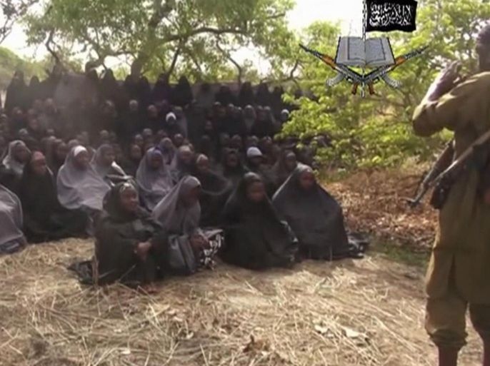 FILE - This Monday, May 12, 2014, file image taken from video by Nigeria's Boko Haram terrorist network, shows the alleged missing girls abducted from the northeastern town of Chibok. On the first anniversary of the kidnapping by Islamic extremists of hundreds of girls from a school in northeast Nigeria, President-elect Muhammadu Buhari said Tuesday, April 14, 2015, that he cannot promise to find the 219 who are still missing. A year after the April 14-15, 2014, mass abduction at a school in Chibok. (AP Photo)