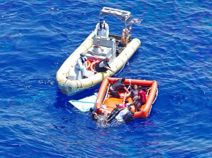 In this photo taken on Wednesday, Aug. 5, 2015 and made available Thursday, Aug. 6, migrants climb onto a rescue dinghy as rescuers approach it on the scene of the capsizing and sinking of a fishing boat in the Mediterranean sea off Libya. The Italian coast guard and Irish navy said at least 367 people were saved, although 25 bodies also were found as many other are feared to have died during the capsizing of the fishing boat in the latest human smuggling tragedy. (Italian Navy VIA AP Photo)