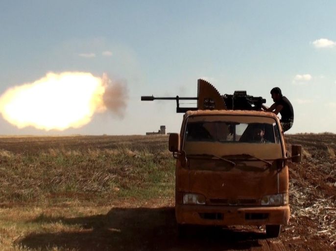 ALEPPO, SYRIA - JUNE 12 : A Syrian opposition group member attacks Daesh militants with an heavy artillery in Soran district of Syria's Aleppo on June 12, 2015.