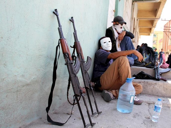 Masked members of YDG-H, youth wing of the outlawed Kurdistan Workers Party (PKK), sit next to their weapons in Silvan, near the southeastern city of Diyarbakir, Turkey, August 17, 2015. The PKK has attacked military targets on a near-daily basis since the Turkish government launched air strikes on rebel camps in northern Iraq on July 25, wrecking a two-year-old ceasefire. REUTERS/Sertac Kayar