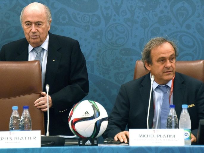 (FILE) A file picture dated 25 July 2015 of FIFA President Joseph Blatter (L) taking a seat next to UEFA President Michel Platini (R) during a seminar ahead of the Preliminary Draw for the FIFA World Cup 2018 in St.Petersburg, Russia. Michel Platini on 29 July 2015 confirmed his intention to run for the FIFA presidency as successor to Joseph Blatter. Platini said in a statement on the UEFA website he has written to the 209 members of FIFA declaring his candidacy and asking for support in his bid to lead the global football governing body.