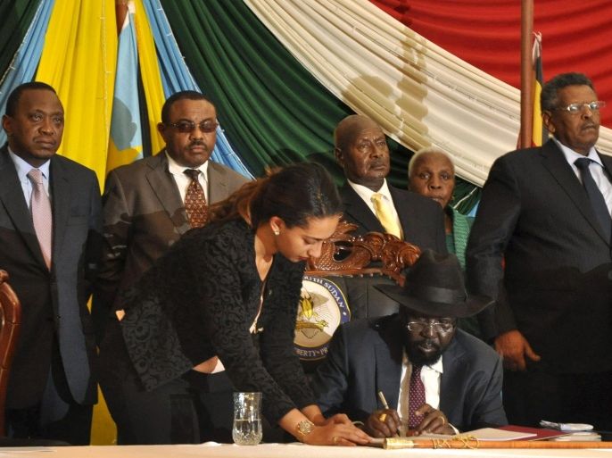 South Sudan's President Salva Kiir (seated) signs a peace agreement in South Sudan's capital Juba, August 26, 2015. Also pictured are Kenya's President Uhuru Kenyatta (L) and Ethiopia's Prime Minister Hailemariam Desalegn (2nd L), Uganda's President Yoweri Museveni (in yellow tie), and Sudan's First Vice President Bakri Hassan Saleh (R). Kiir signed a peace deal on Wednesday to end a 20-month conflict with rebels, but he told regional African leaders at the ceremony that he had "serious reservations". Kiir, who has led South Sudan since it seceded from Sudan in 2011, had asked for more time for consultations last week, drawing threats of U.N. sanctions if he failed to ink it within a two-week deadline. REUTERS/Jok Solomun