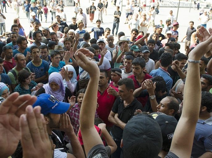 Migrants demonstrate demanding to be let on trains to Germany in the transit area designated for them at Keleti railway station in Budapest, Hungary, Sunday, Aug. 30, 2015. (Peter Lakatos/MTI via AP)