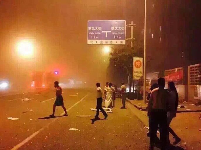 BEST QUALITY AVAILABLEThis photo taken with a mobile phone on August 12, 2015 and received from a Weibo user shows people taking shelter on a street after a huge explosion in the northern Chinese port city of Tianjin. At least 50 people were wounded on August 12 by a huge explosion of inflammable material stored in a warehouse in the northern Chinese port city of Tianjin, state media reported. The official Xinhua news agency said the blast happened at around 11:30 pm (1630 GMT), when a deafening bang was heard and plumes of flame lit up the night sky, scattering dust dozens of metres into the air. AFP PHOTO -- CHINA OUT --