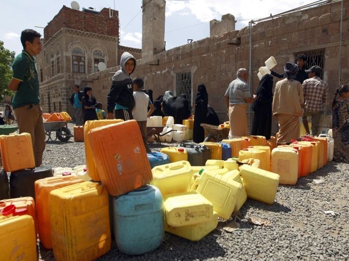 Yemenis wait to fill jerrycans with water from a public tap amid an acute shortage of water supply to houses in the capital Sanaa on August 22, 2015. AFP PHOTO / MOHAMMED HUWAIS