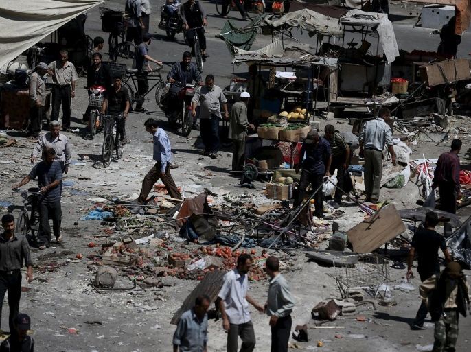 People inspect the damage after what activists said were airstrikes by forces loyal to Syria's President Bashar al-Assad on a busy marketplace in the Douma neighborhood of Damascus, Syria August 12, 2015. Syrian government air strikes on rebel-held areas near Damascus killed at least 31 people on Wednesday, and insurgents bombarded the capital with rockets that killed at least 13 people, the Syrian Observatory for Human Rights reported. REUTERS/Bassam Khabieh NO ARCHIVES