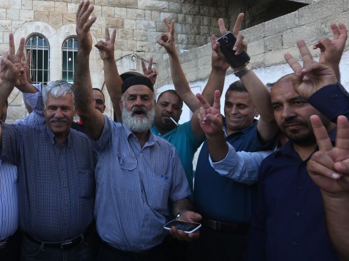 Palestinian Naser al-Deen Allan (C), the father of the prisoner Mohammed Allan who is held by Israel without trial and who is on a long-term hunger strike, celebrates with friends following news from Mohammed 's lawyer regarding the suspension of his detention, at the family home in the West Bank city of Nablus on August 19, 2015. Israel's High Court suspended the detention-without-trial order on hunger-striking Palestinian prisoner Allan but said he must remain in hospital pending a decision on his future. AFP PHOTO / JAAFAR ASHTIYEH
