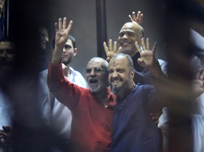 Muslim Brotherhood Supreme Guide Mohammed Badie (C-L) and top leader Mohammed al-Beltagi (C-R) along other Brotherhood members react inside defendants' cage in the courtroom during a trial session, in Cairo, Egypt, 16 June 2015. A Cairo court on 16 June 2015 sentenced former president Mohamed Morsi to death over jailbreaks during Egypt's 2011 uprising. Muslim Brotherhood Supreme Guide Mohammed Badie, former parliament speaker Saad al-Katatni and three other co-defendants also received the death penalty in the case. In a related case, three Muslim Brotherhood leaders were sentenced to hang for conspiring with foreign powers. Morsi and 16 others received life sentences in that case. EPA/ALI MALKI / ALMASRY ALYOUM EGYPT OUT