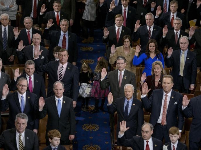 Members of the House are sworn in during a ceremony on the floor of the House of Representatives as the 114th Congress convenes on Capitol Hill January 6, 2015 in Washington, DC. Republican John Boehner was re-elected and sworn in Tuesday as speaker of the US House of Representatives, overcoming a surprisingly robust attempt to oust him by two dozen hardcore conservatives. Boehner received 216 of the 408 votes cast in the chamber, winning as expected over Democrat leader and former House speaker Nancy Pelosi, who received 164 votes. AFP PHOTO/BRENDAN SMIALOWSKI