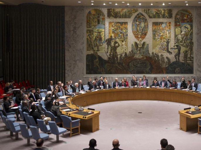 In this photo provided by the United Nations, the U.N. Security Council votes to beef up its peacekeeping force in South Sudan, Tuesday, Dec. 24, 2013, at United Nations headquarters. The U.N. announced earlier in the day that its investigators discovered a mass grave in the town of Bentiu in oil-rich Unity state. A total of 34 bodies were found in two graves according to a U.N. human rights office spokesperson. (AP Photo/The United Nations, Eskinder Debebe)